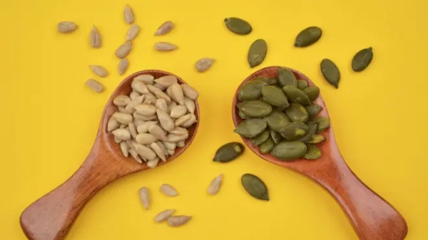 Насіння гарбуса і соняшника у ложках на столі 